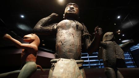 Three large royal statues of the Kingdom of Dahomey are displayed at the Quai Branly Museum in Paris, France