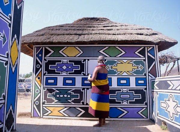 An Ndebele woman painting her front walls