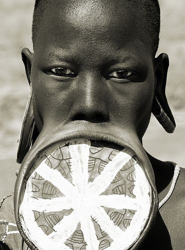 what does the African tribal lip plate Symbolise